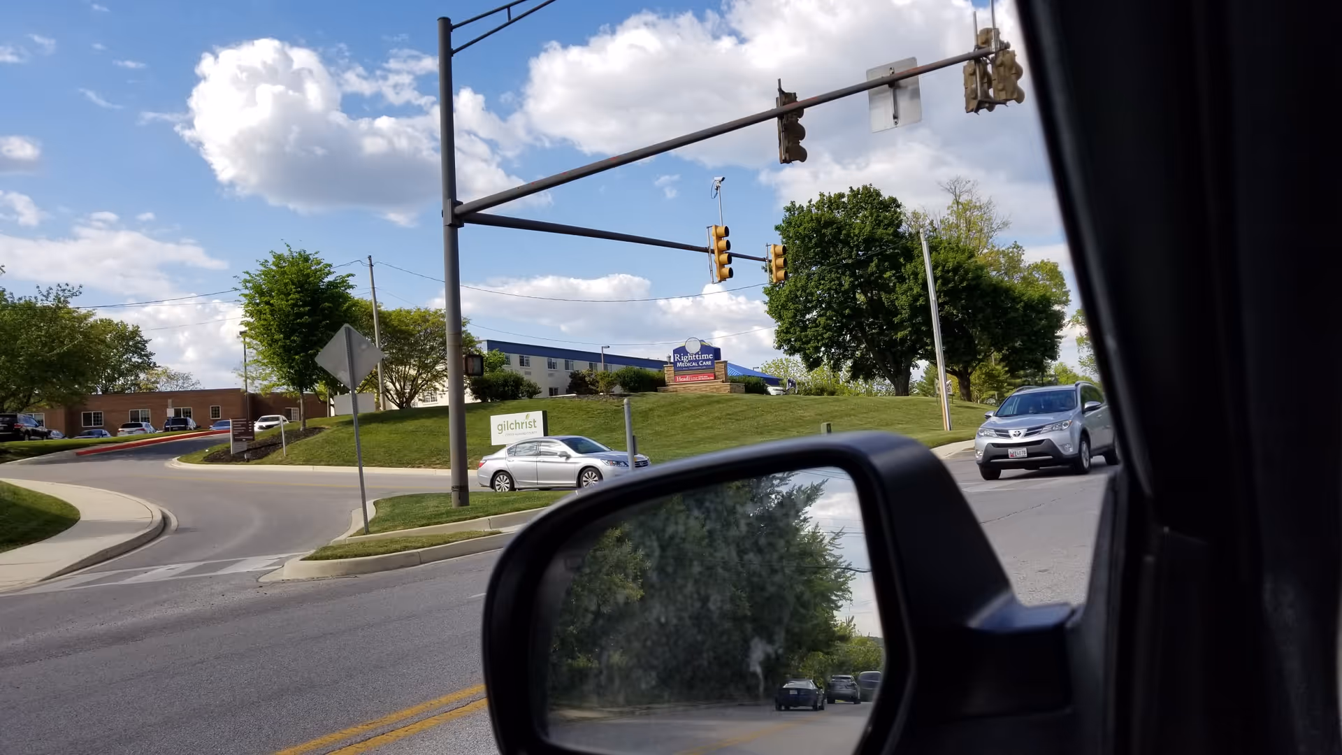 Street view outside Gilchrist Center Howard County with cars and traffic signals