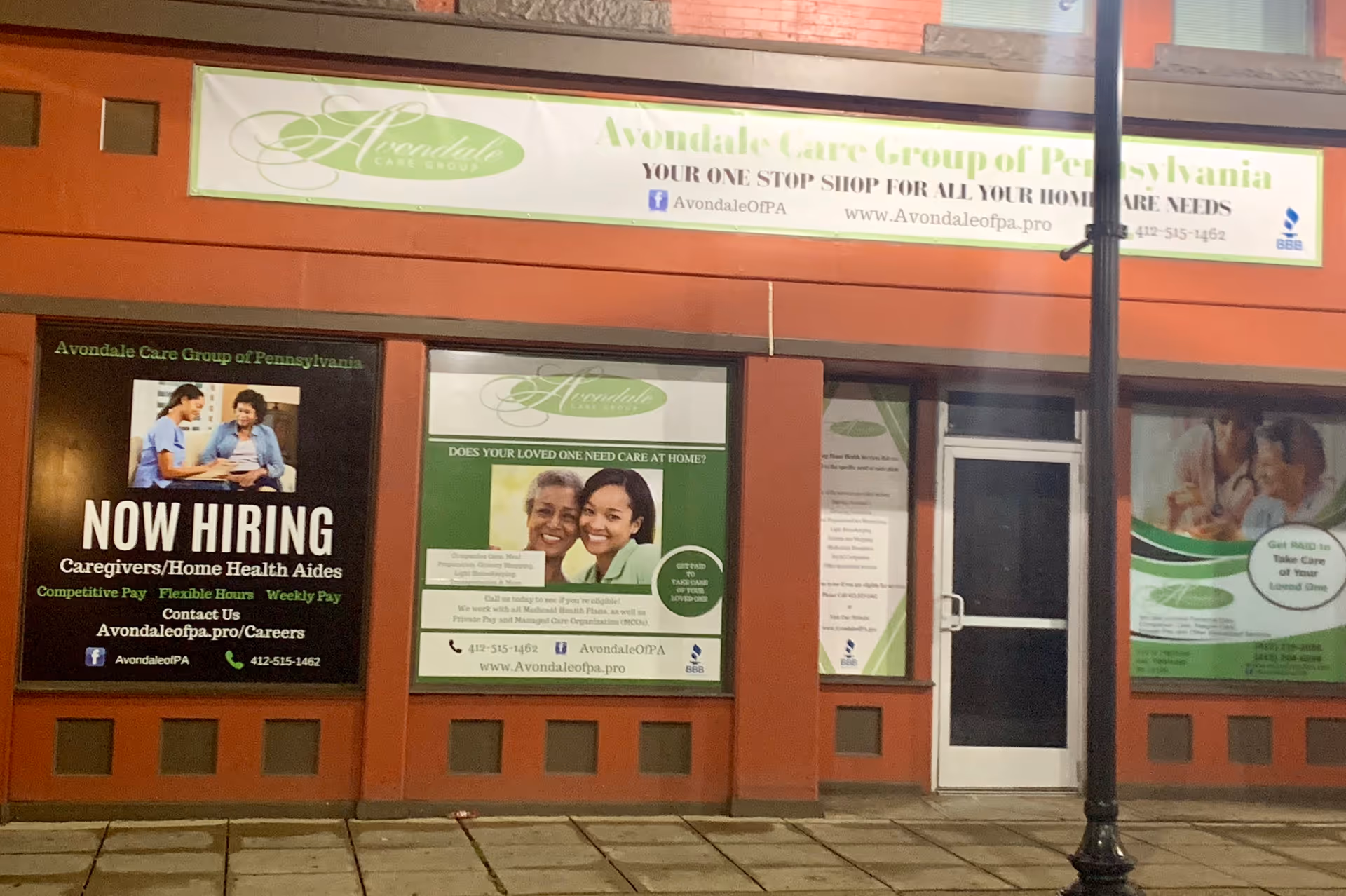 Front of Avondale Care Group storefront with banners and posters