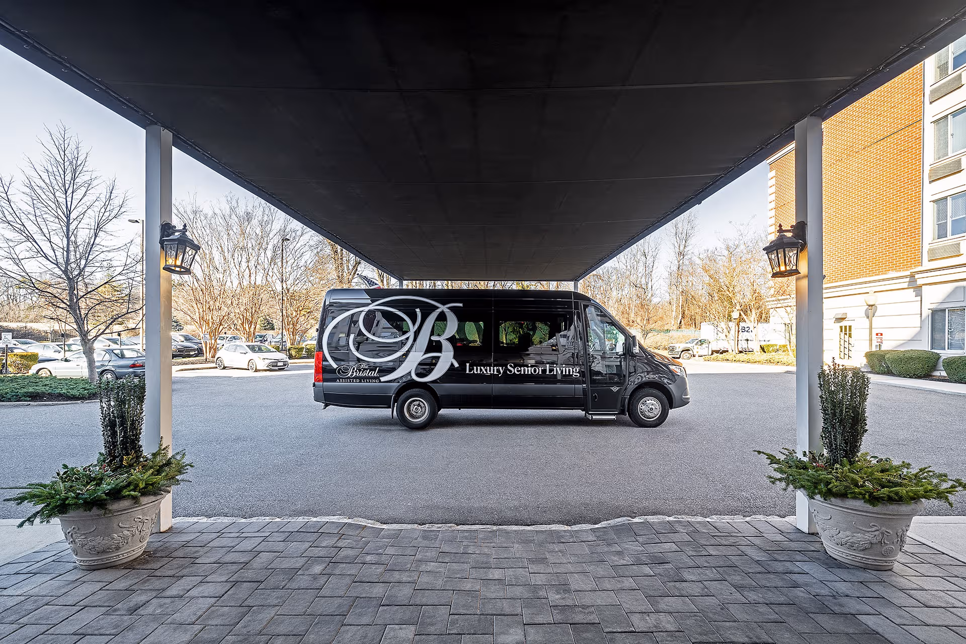 Black Bristal van parked under a covered entrance at the facility.