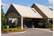 Exterior view of Valley View Care Center entrance with brick facade and curved awning.
