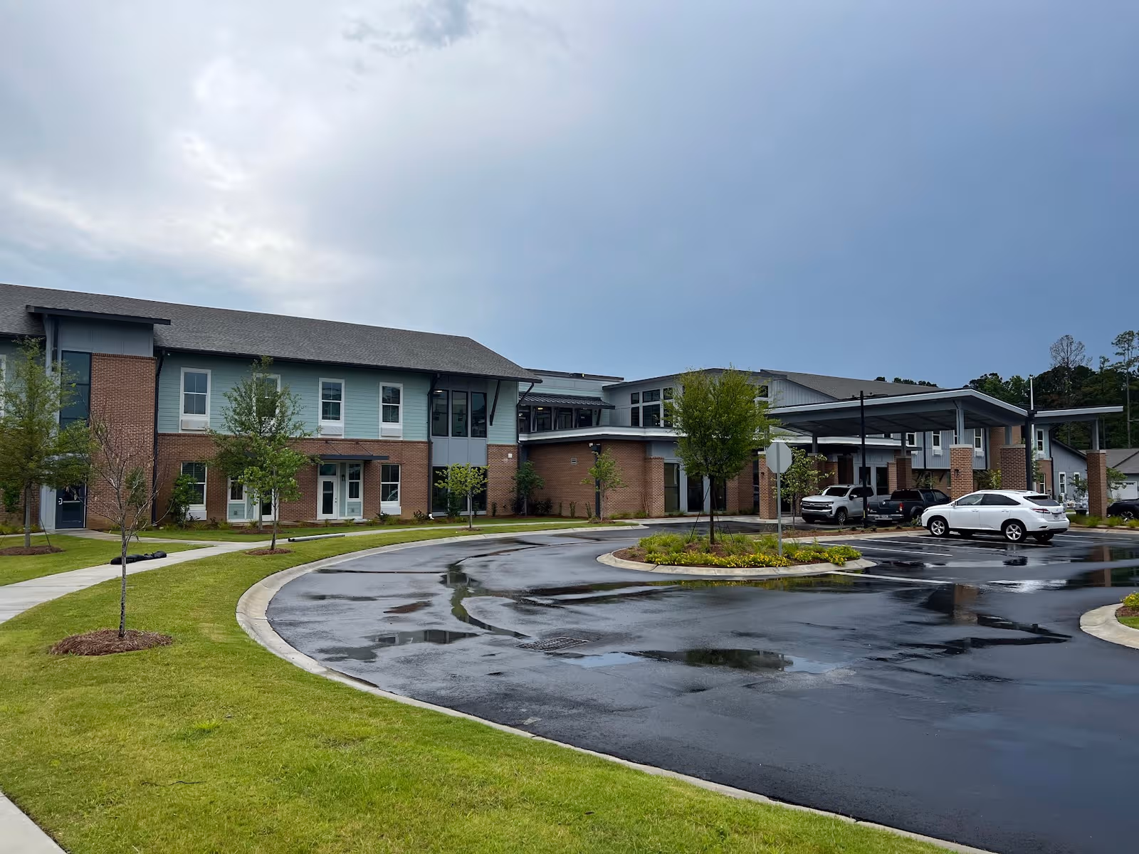 Exterior view of The Marsh at Carolina Park with a circular driveway and parked cars.
