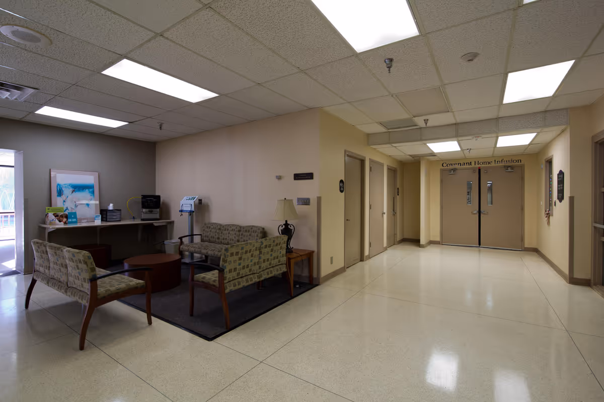 Interior waiting area at Covenant Home Infusion with sofas, chairs, and double doors.