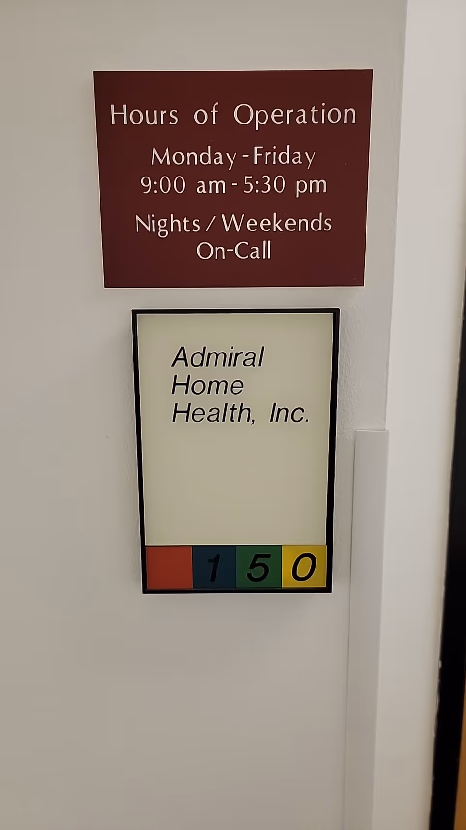 Wall with signs displaying hours of operation and Admiral Home Health, Inc.
