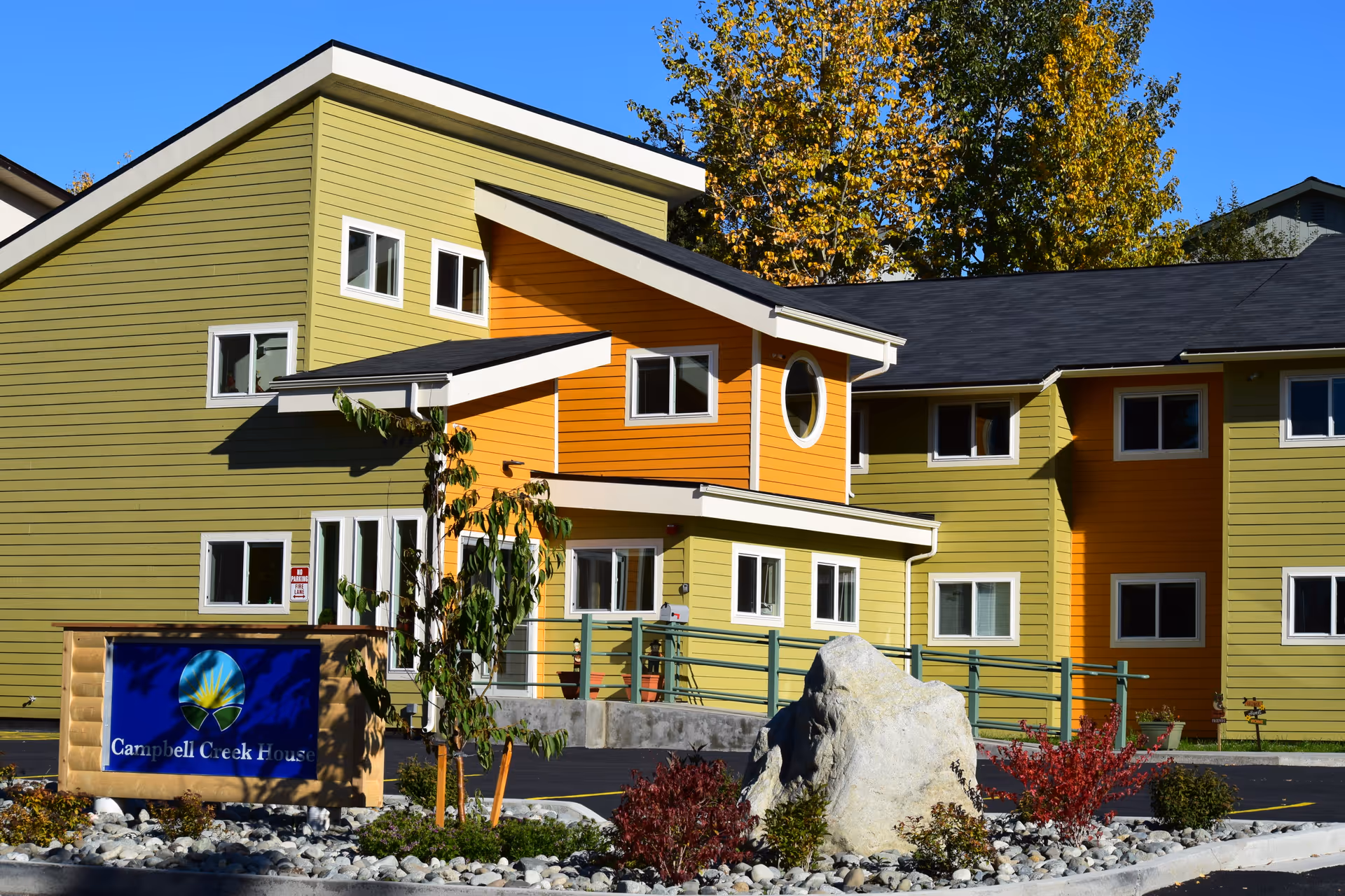 Colorful exterior of Campbell Creek House senior living facility.