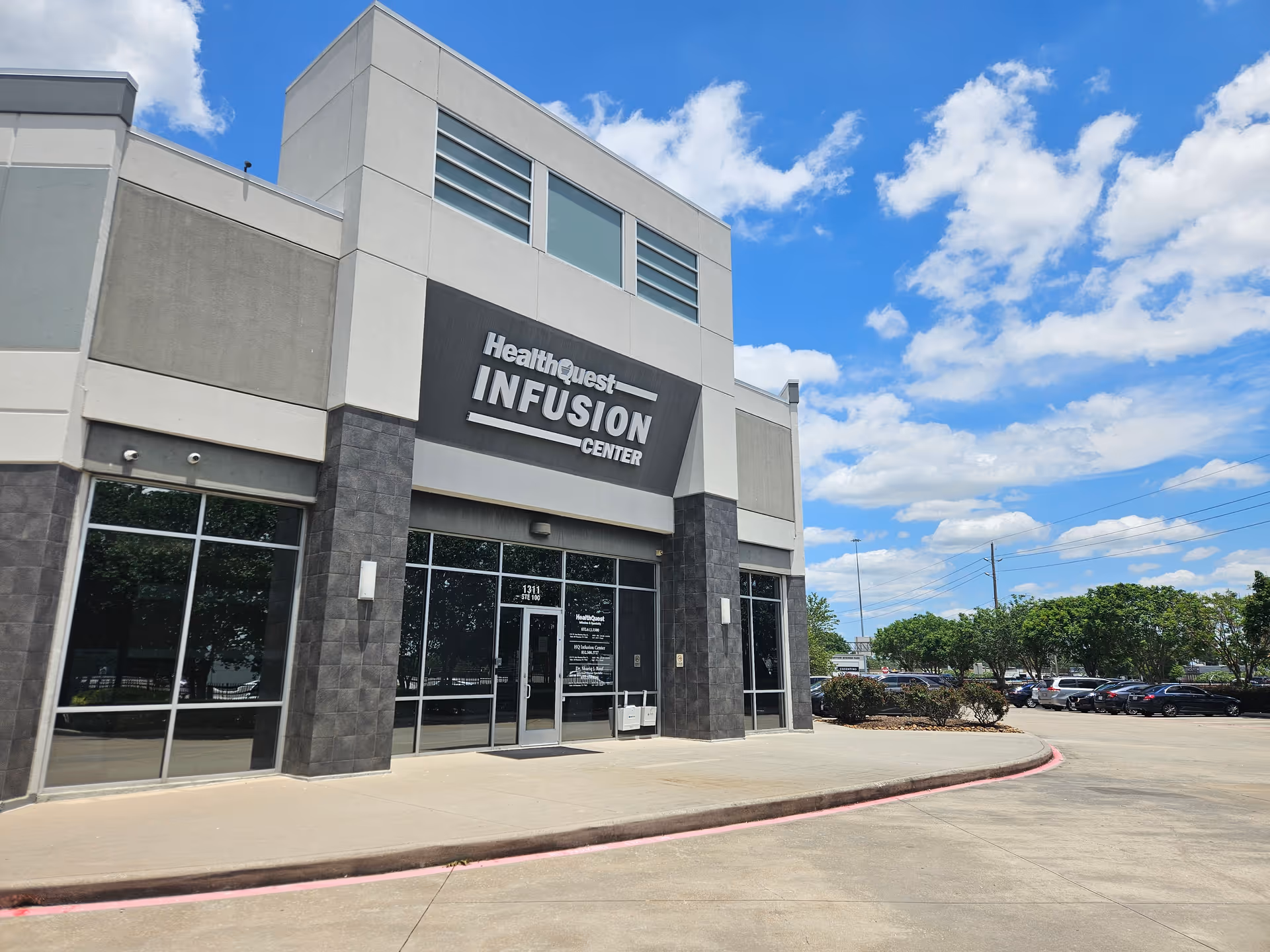 Modern HealthQuest Infusion Center exterior with signage and adjacent parking.