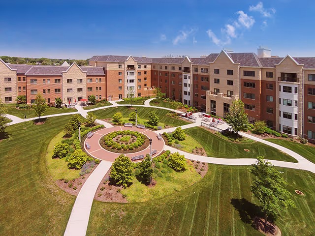 Majestic Care of Livonia outdoor campus with circular garden and brick buildings.