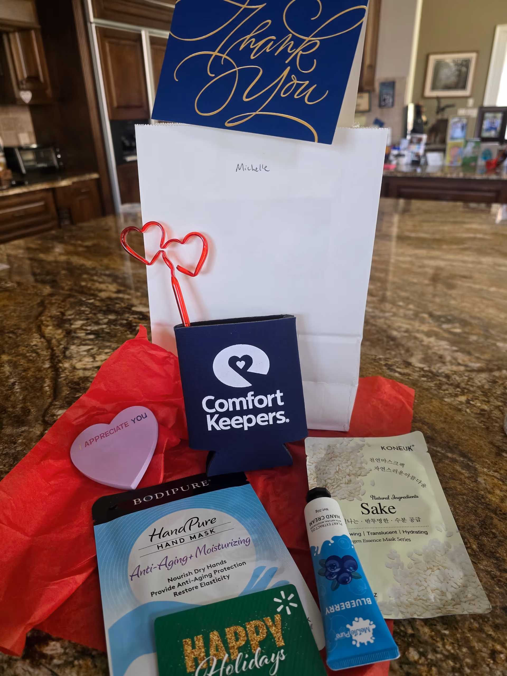 Assorted care items and a thank-you card arrangement on a kitchen island.