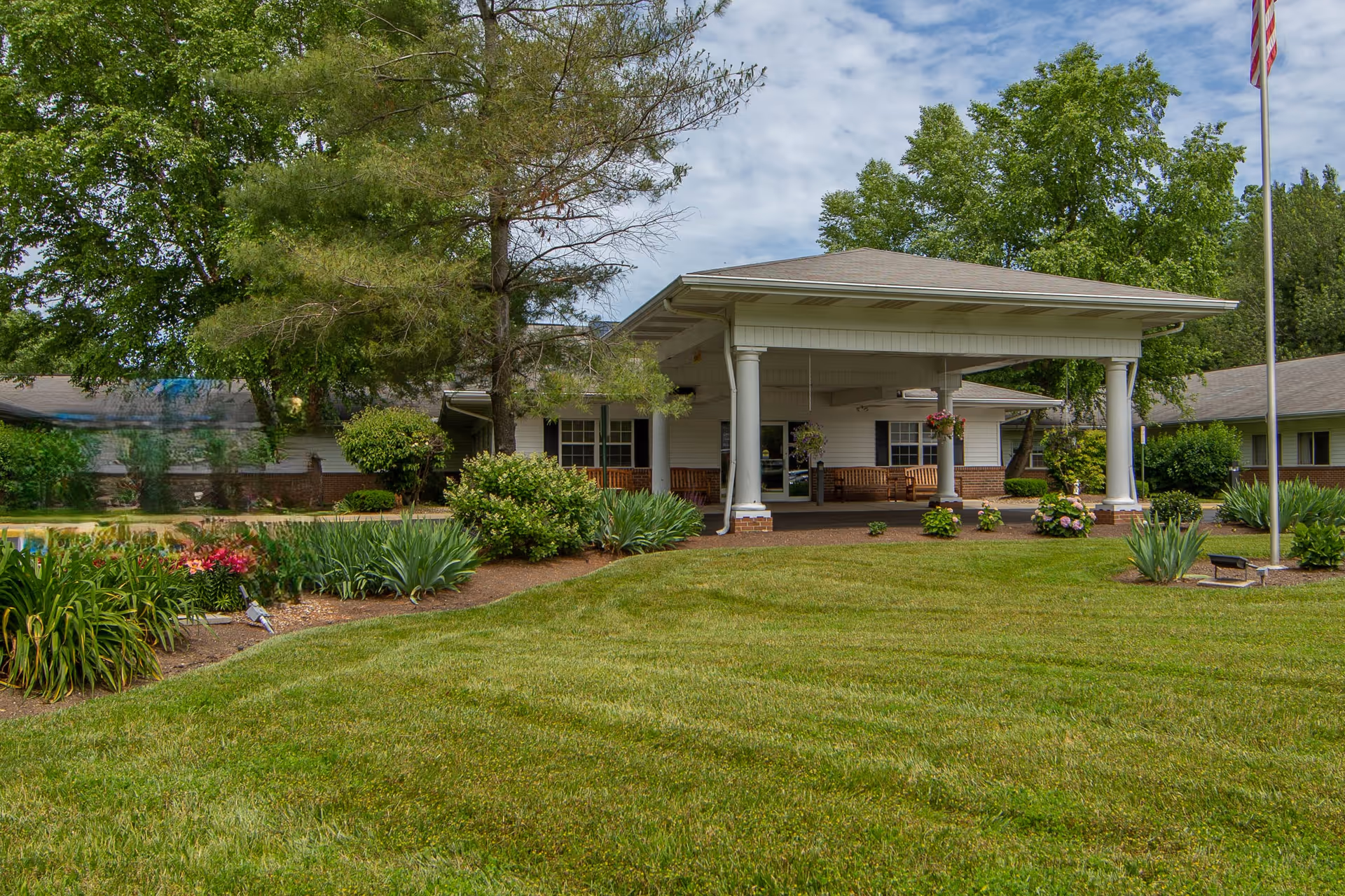 Exterior view of CareCore at Mentor with a covered entrance and landscaped front lawn.