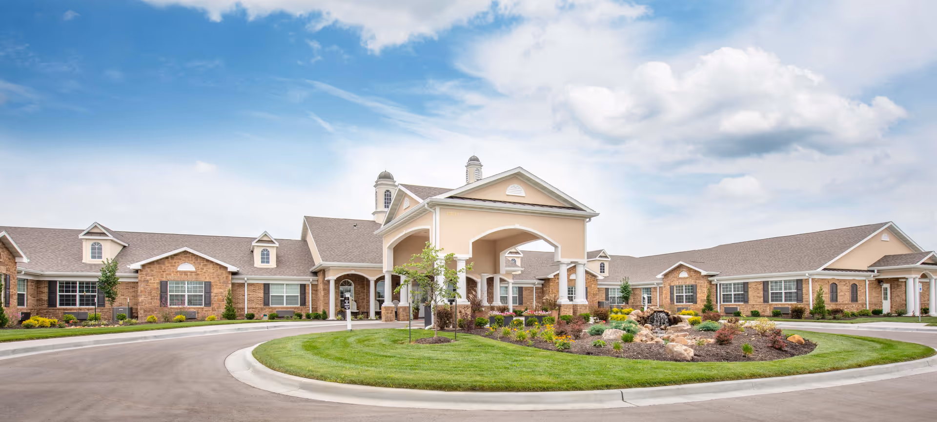 Front exterior view of Benton House of Staley Hills with circular drive and landscaped entrance.