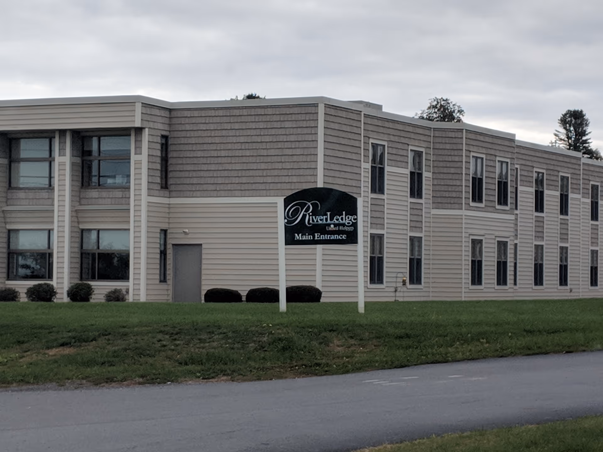 Exterior view of RiverLedge Nursing Home building with main entrance sign.
