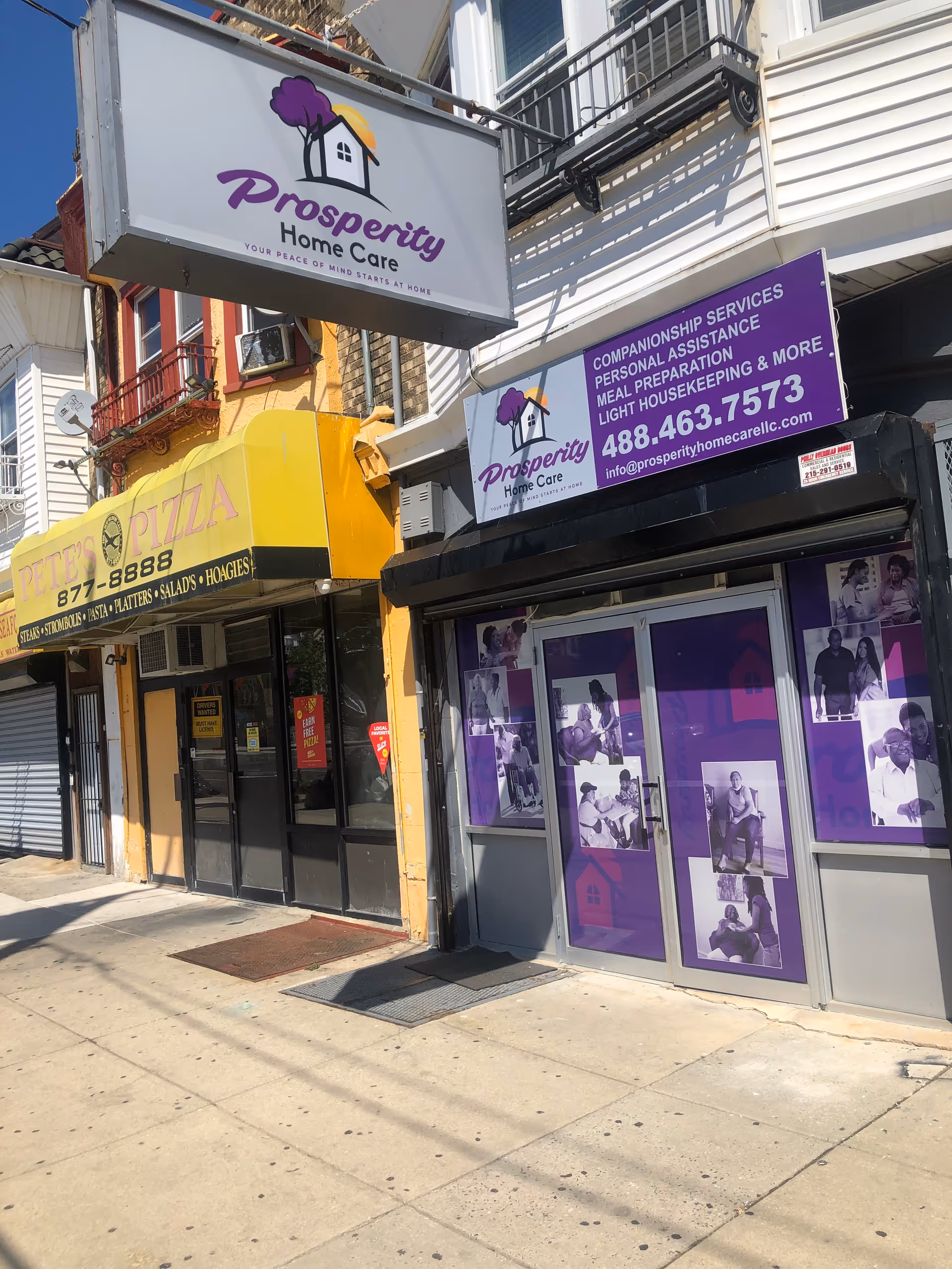 Prosperity Home Care LLC storefront signage along a sidewalk with other shops.