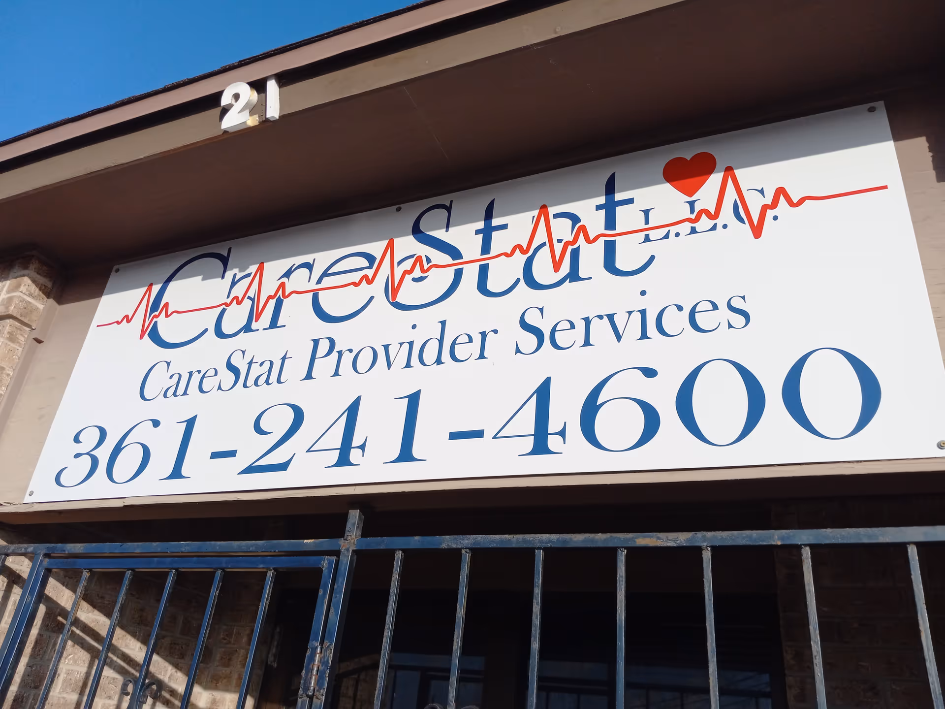 Exterior storefront with a large CareStat provider services sign and phone number.