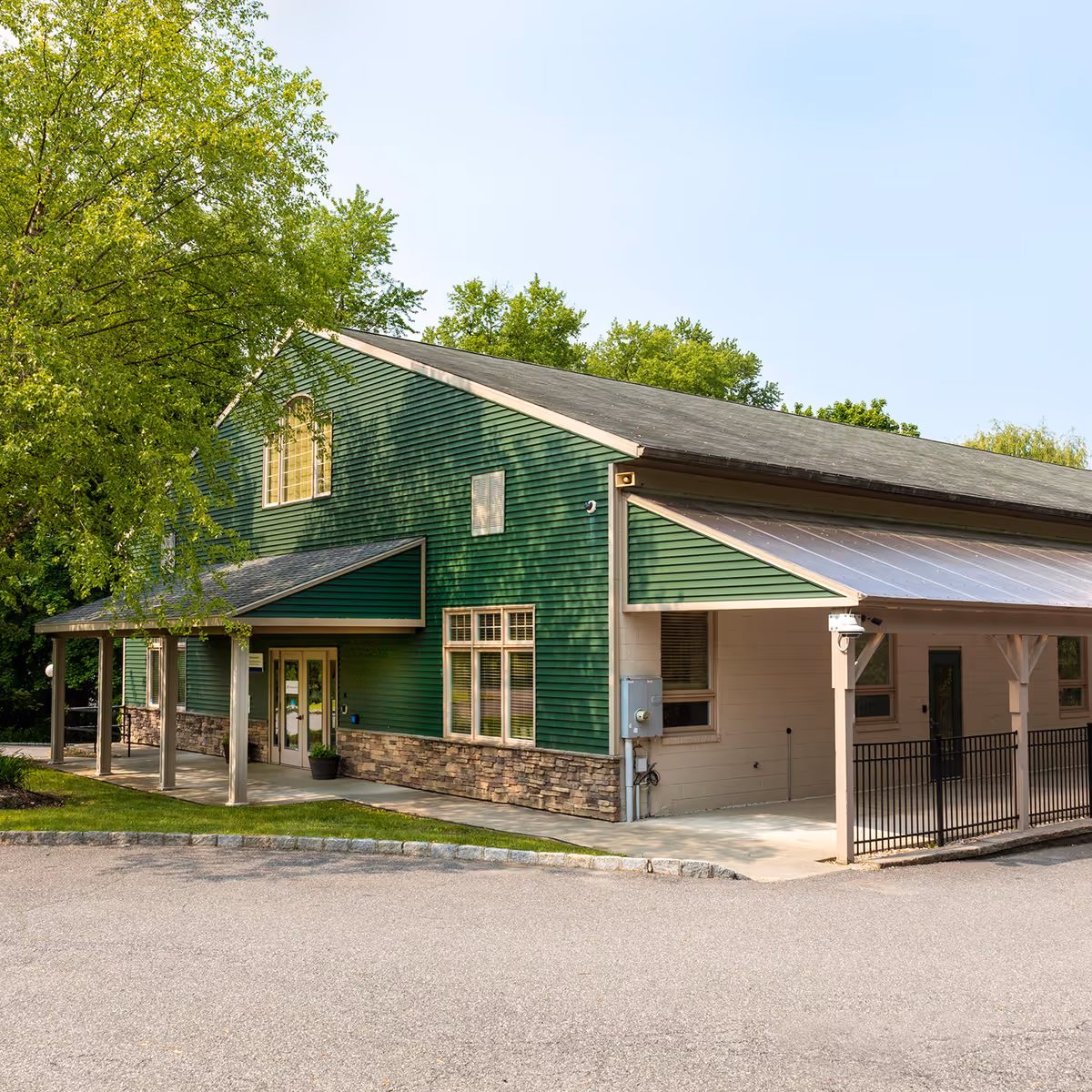 Exterior view of Nuvance Health Physical Rehabilitation at Pawling, green building with stone base.