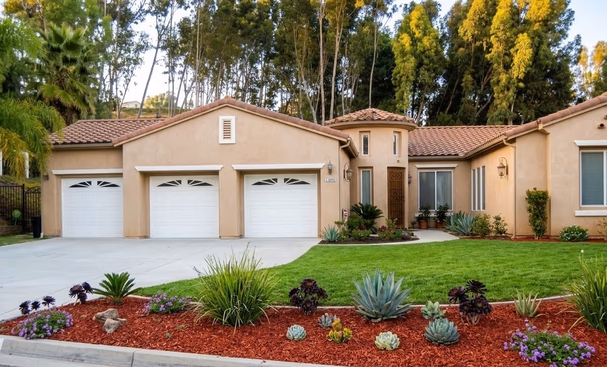 Beige single-story senior living facility with three garages and a manicured front yard.