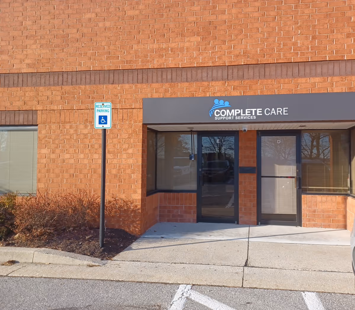 Brick exterior of a facility with Complete Care sign and accessible entrance.