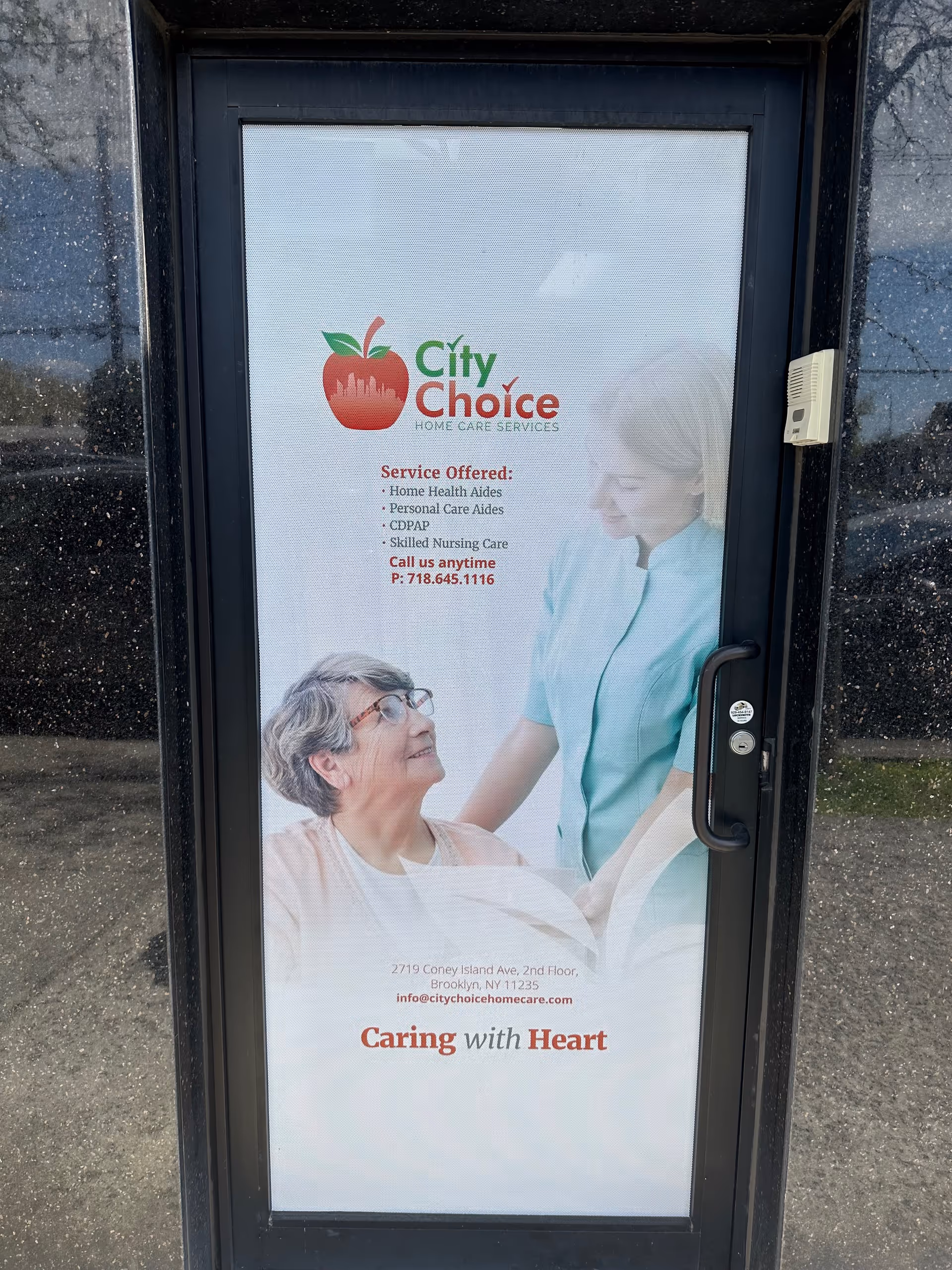 Entrance door features a City Choice Home Care Services poster with a caregiver and elderly woman.