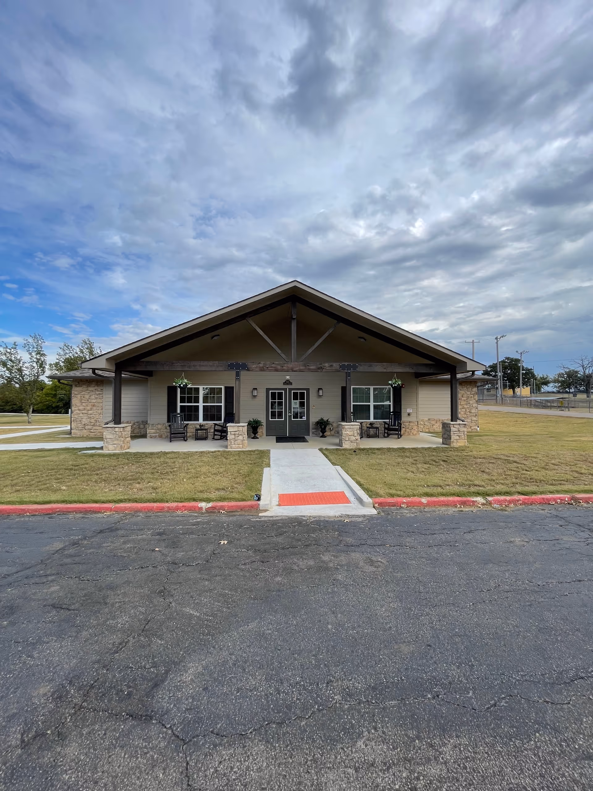 Front view of Oakridge Home, LLC facility with entrance, porch, and parking.