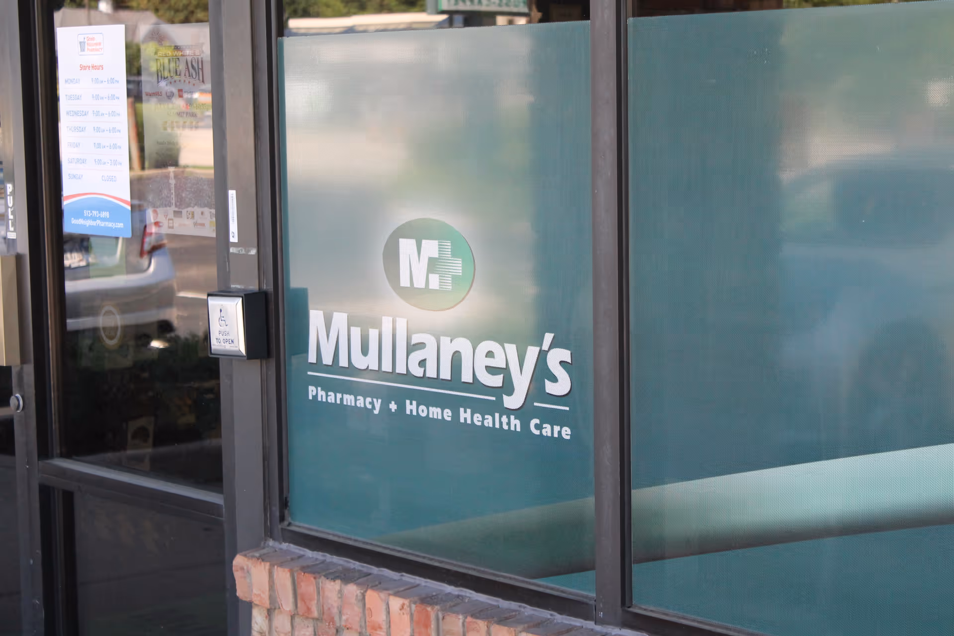 Front exterior of Mullaney's storefront with glass window displaying logo signage.