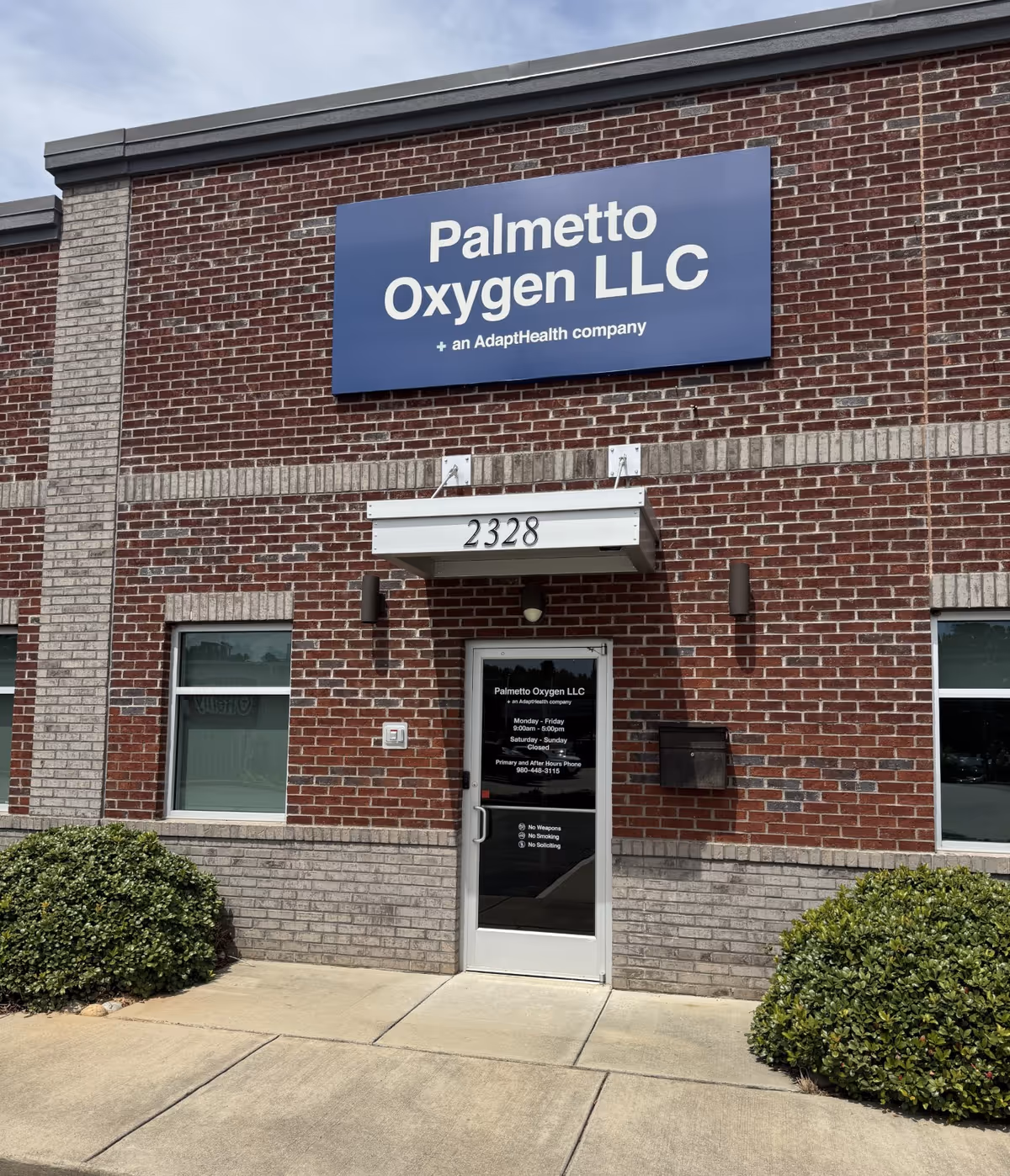 Brick facility exterior with a large Palmetto Oxygen LLC sign above the entrance.