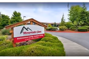 Front view of Mountain Glen Retirement and Assisted Living building with a landscaped sign.