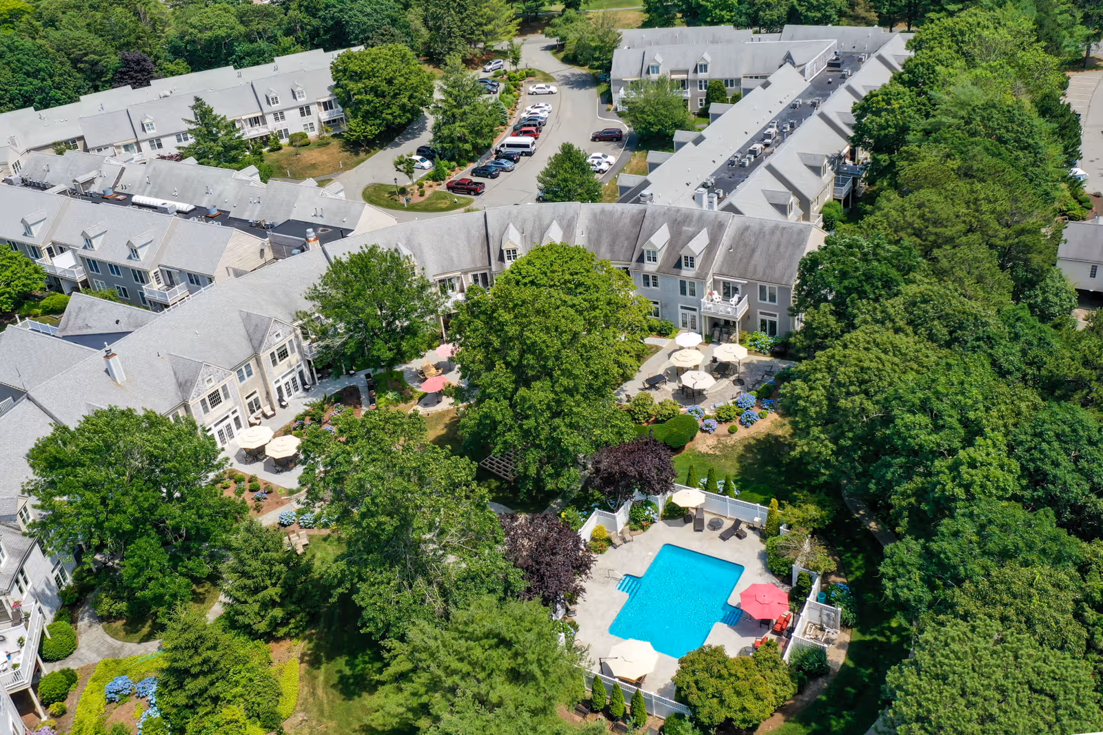 Aerial view of Heatherwood at Kings Way complex with central courtyard, pool, and surrounding trees.