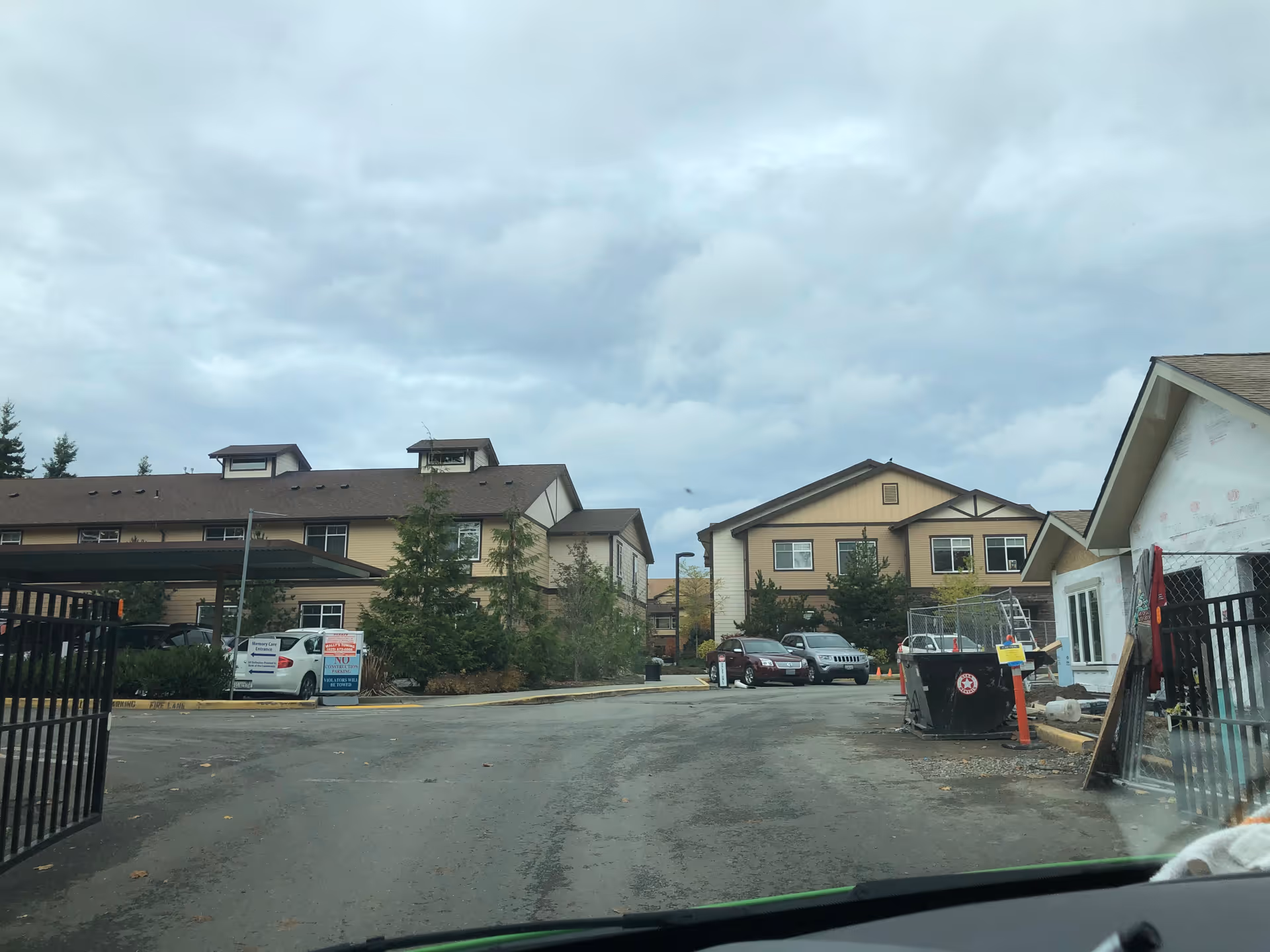 Exterior view of Quail Park of Lynnwood with parked cars and a construction area