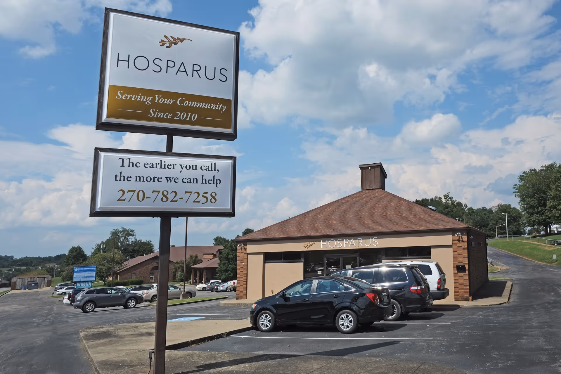 Exterior view of Hosparus Health Barren River facility with sign, building, and cars
