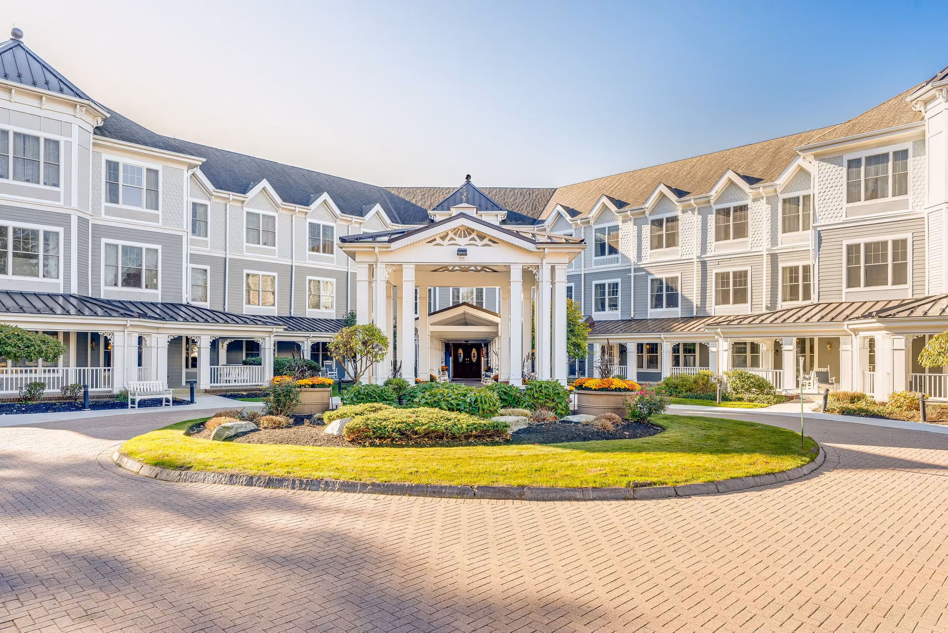 Sunrise of Lynnfield exterior with circular driveway and central entry.