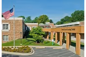 Exterior view of the Calvert County Nursing Center entrance with flag and landscaping.