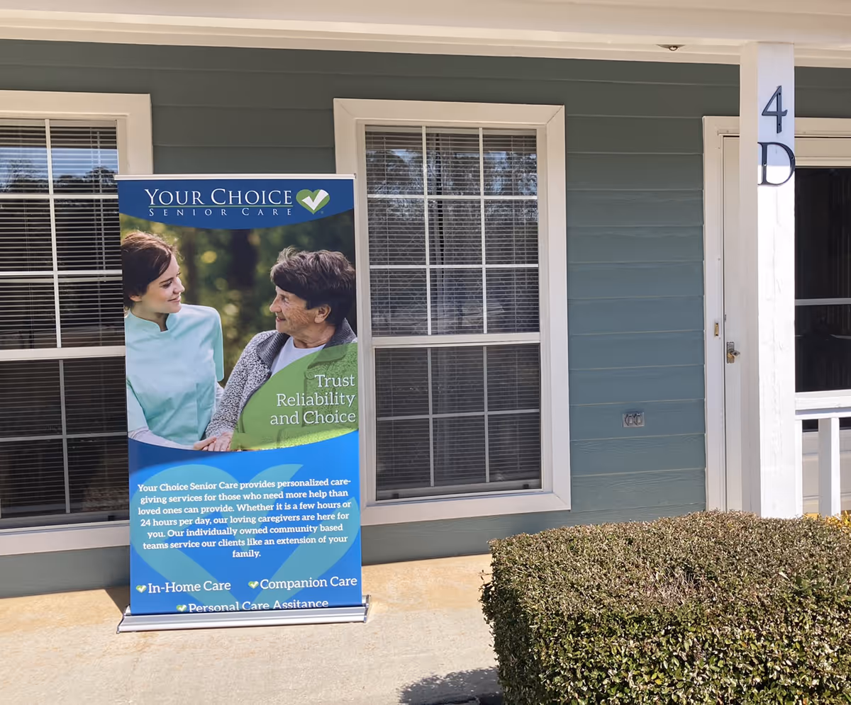 Exterior of Your Choice Senior Care facility with a banner beside windows.