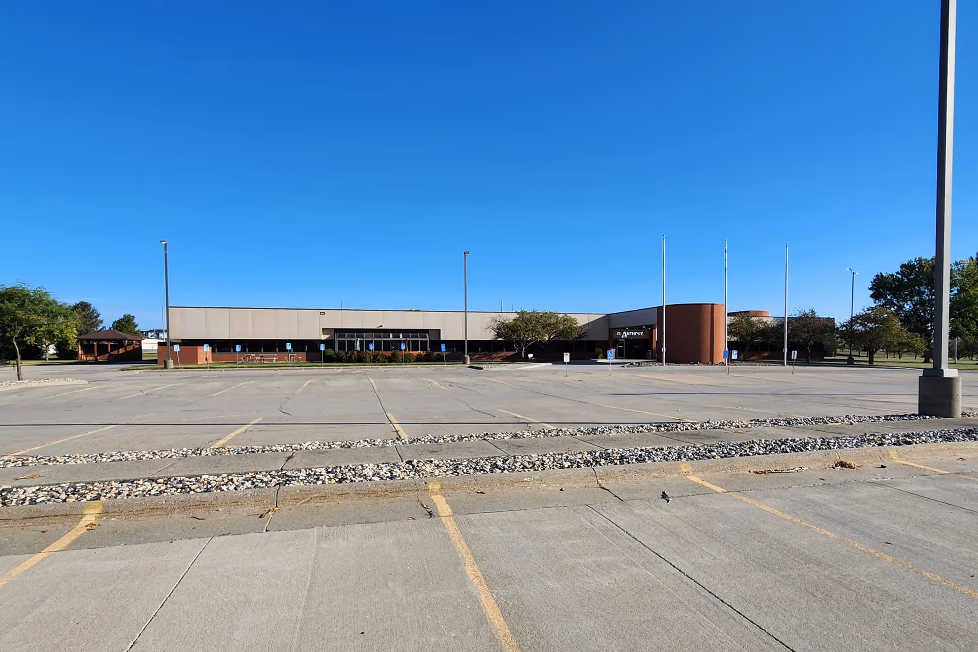 Wide view of the St. Anthony Office Building with a large, empty parking lot.