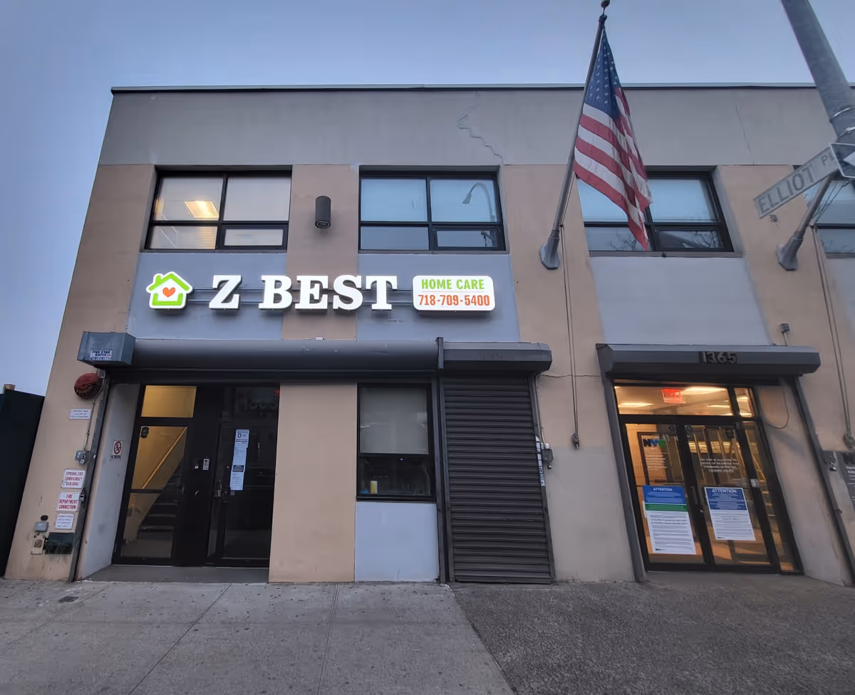 Exterior view of Z Best Home Care building with an American flag and street signage outside.