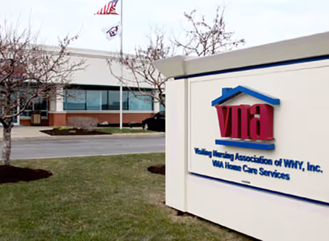 Exterior view of a nursing facility with a sign reading VNA Home Care Services.