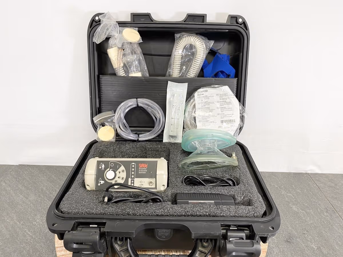 Open hard case containing medical breathing equipment, hoses, and a mask.