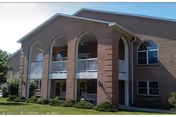Front facade of Serra Mesa Guests Home, a senior facility with brick arches.