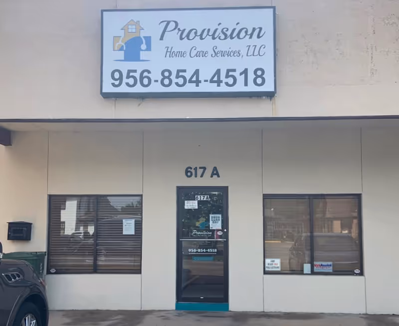 Front of a beige storefront displaying Provision Home Care Services sign and phone.