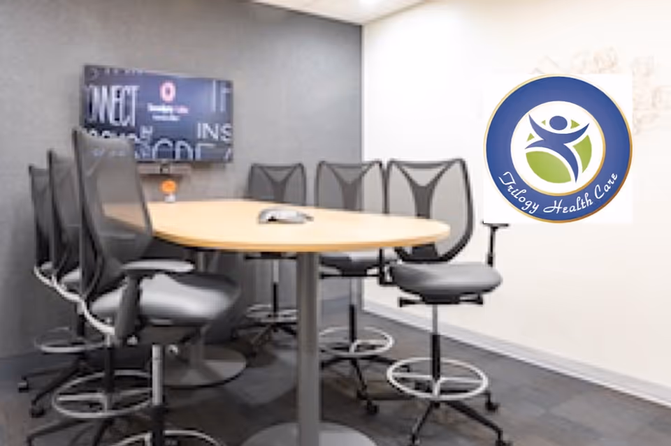 A conference room with a round table and high chairs at Trilogy Health Care.