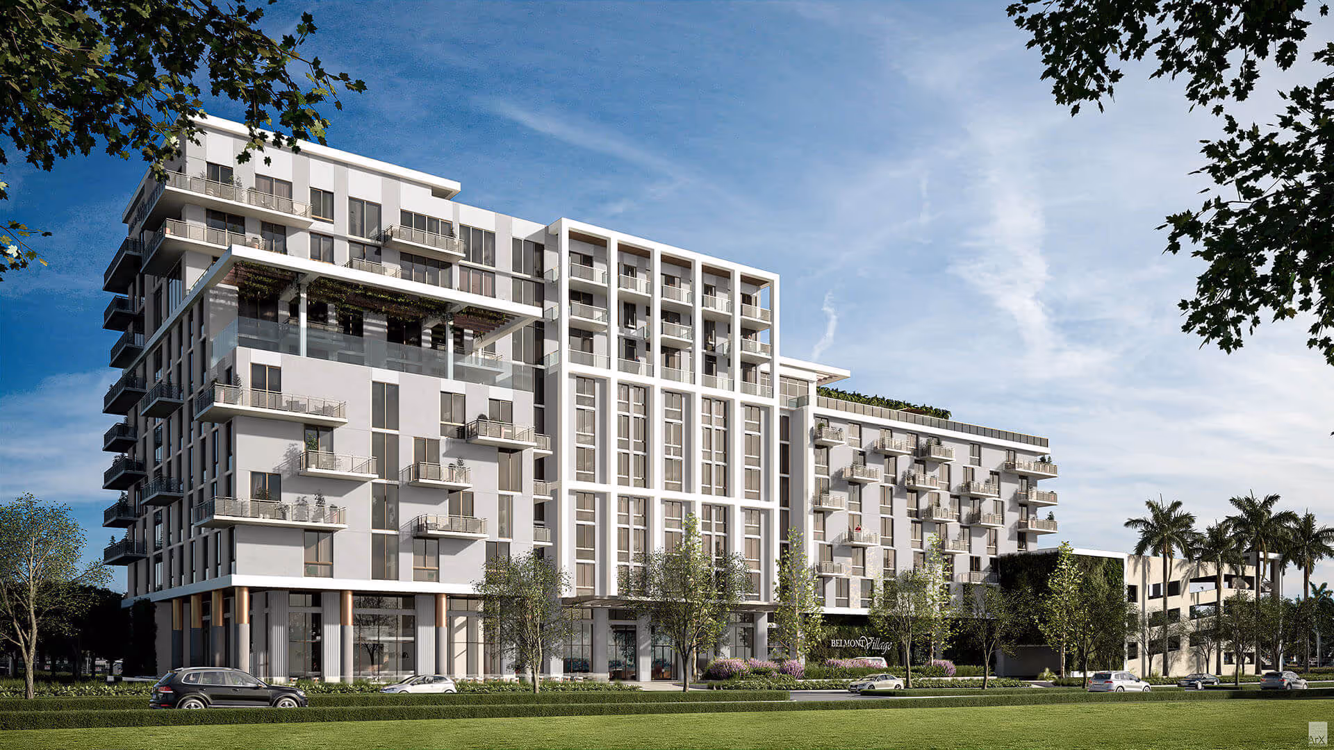 Modern multi-story senior living facility building with balconies, surrounded by trees and parked cars under a blue sky.