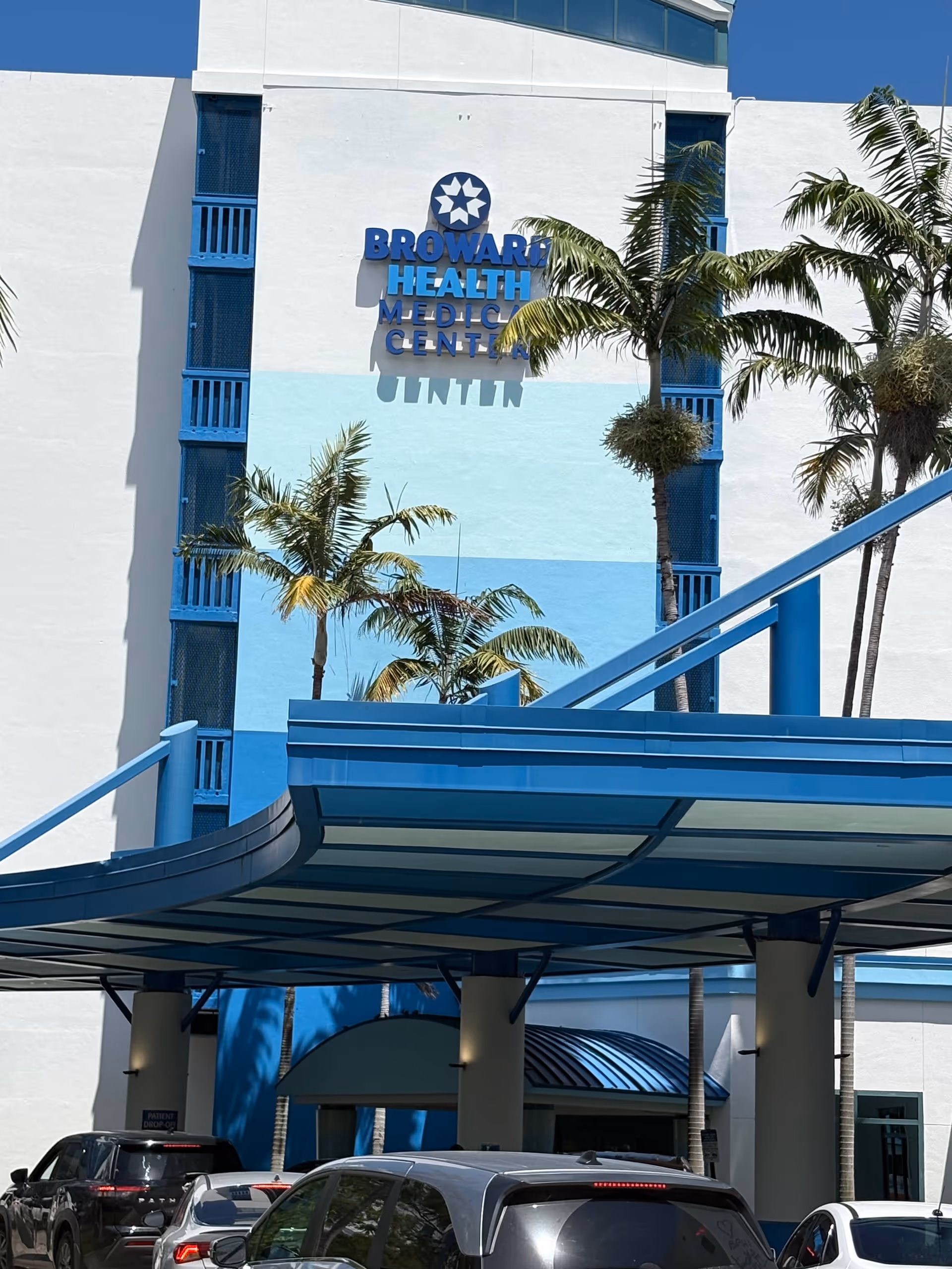 Front view of Broward Health Medical Center exterior with palm trees and blue accents