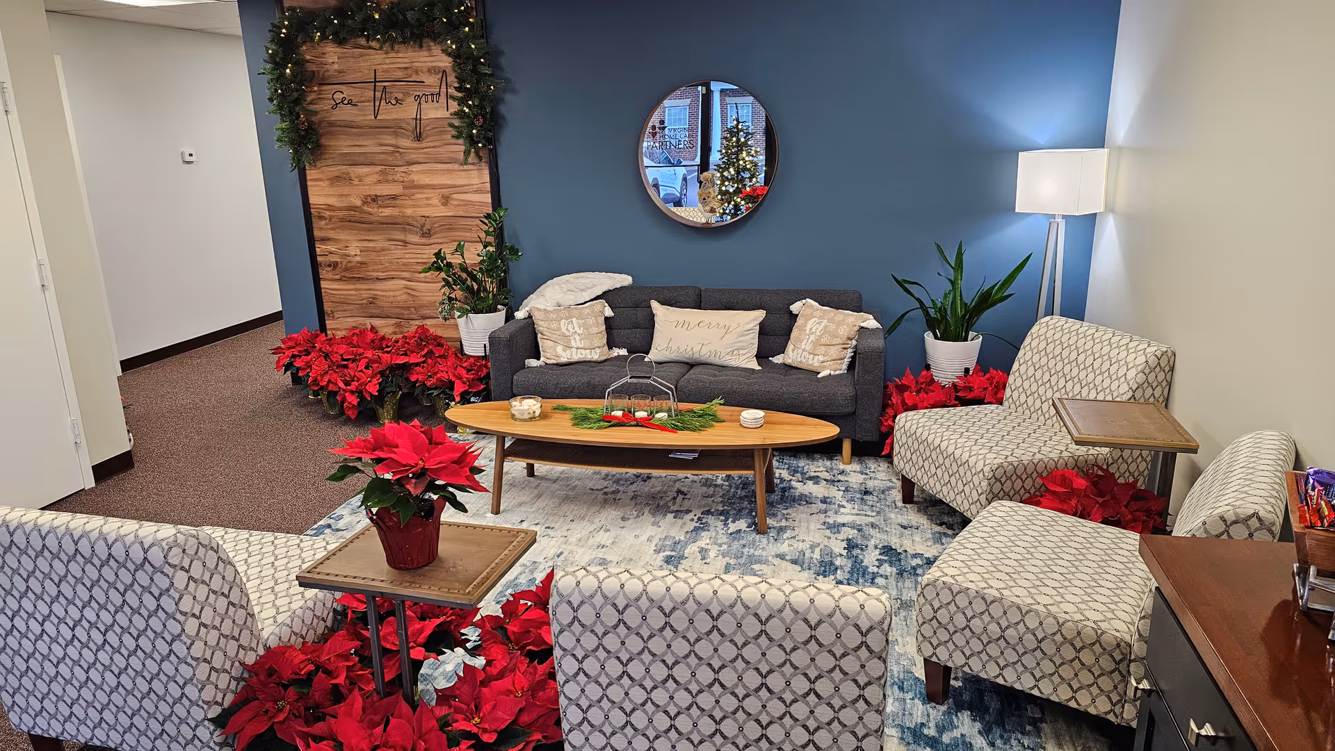 Cozy lounge area with a sofa, chairs, holiday decorations, and a coffee table.