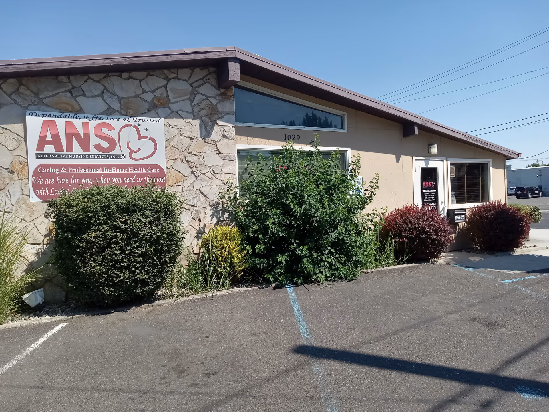 Front view of a single-story building with stone facade and Alternative Nursing Services sign