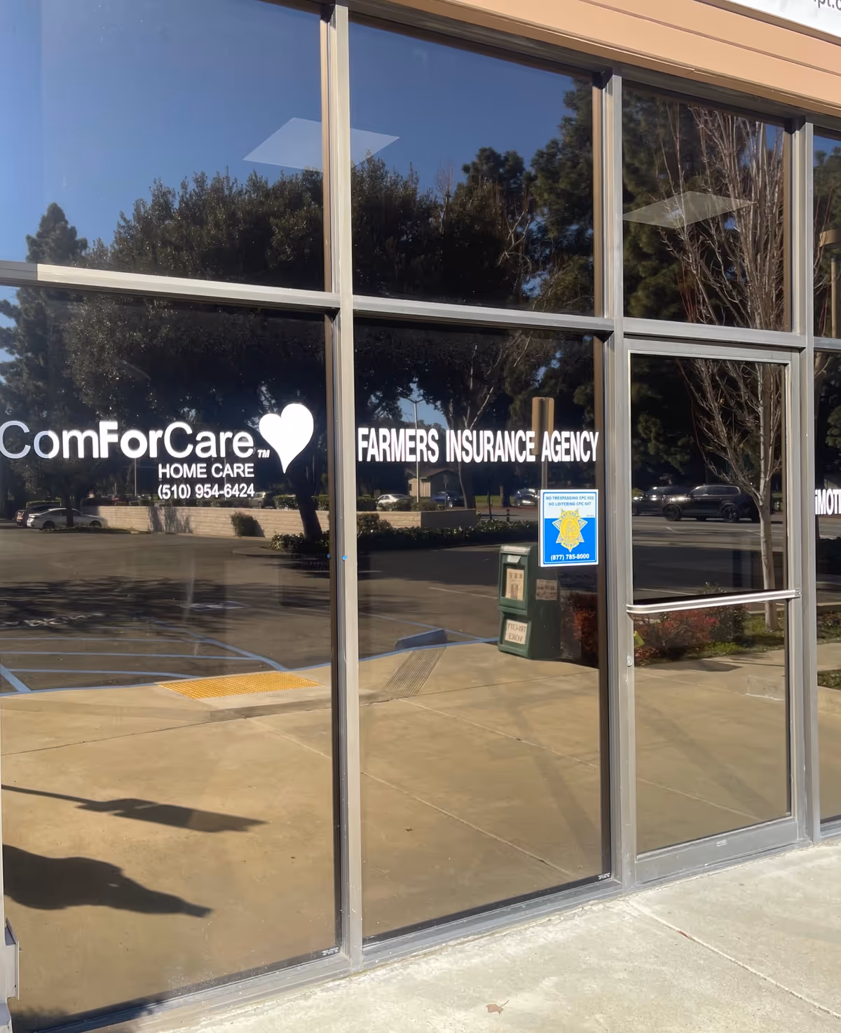 Exterior view of a ComForCare storefront with large glass windows and signage.