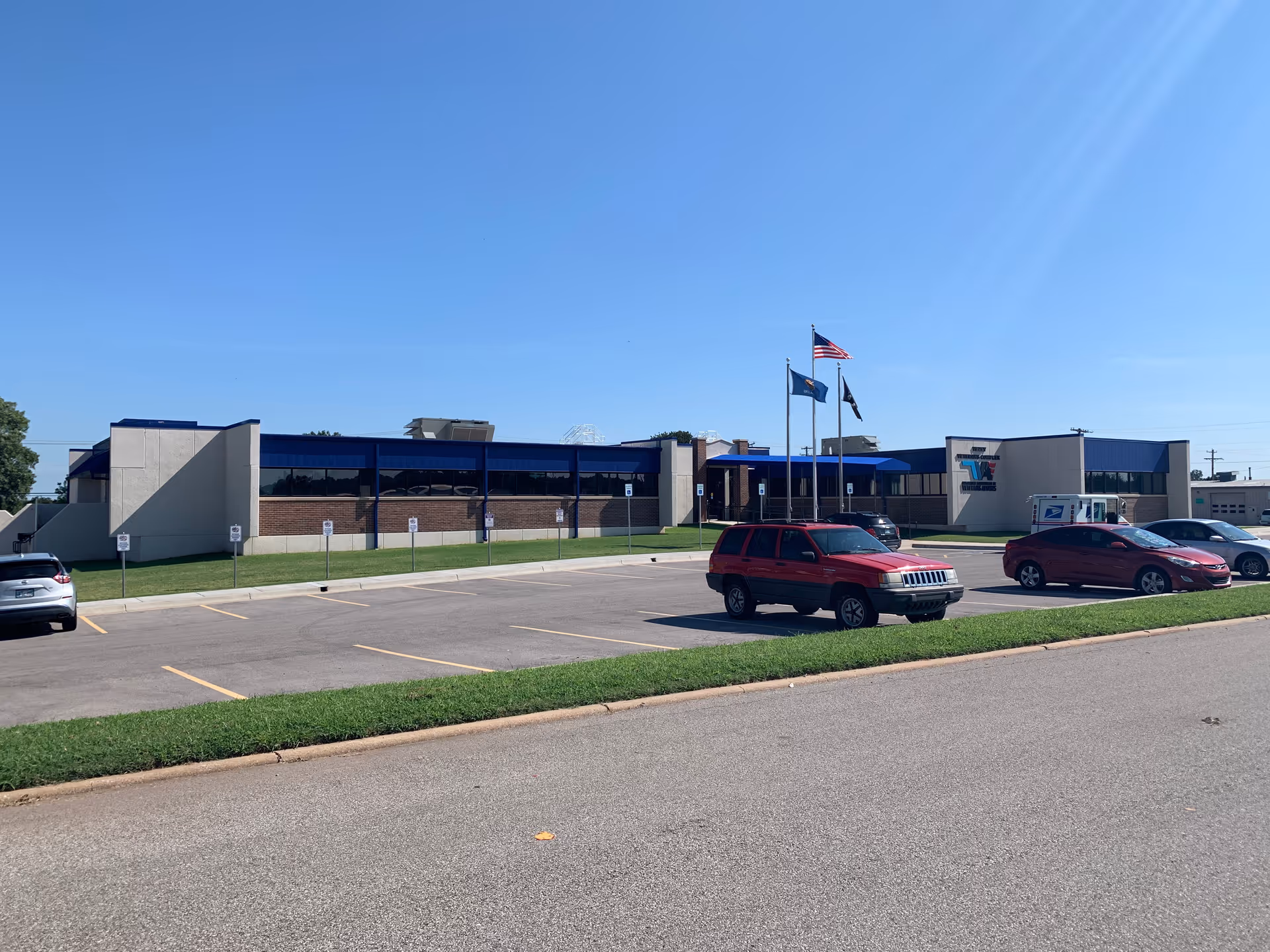 Exterior view of the Oklahoma veterans facility with flags and a parking lot