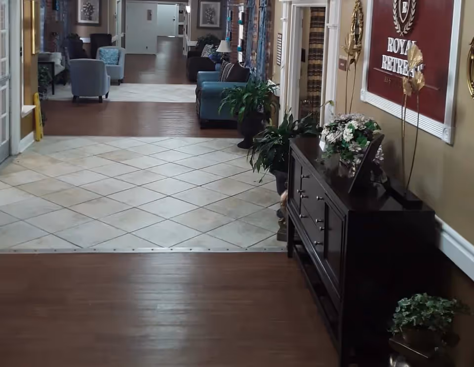Interior corridor of Island Lake Home with seating, plants, and a dark wooden console.
