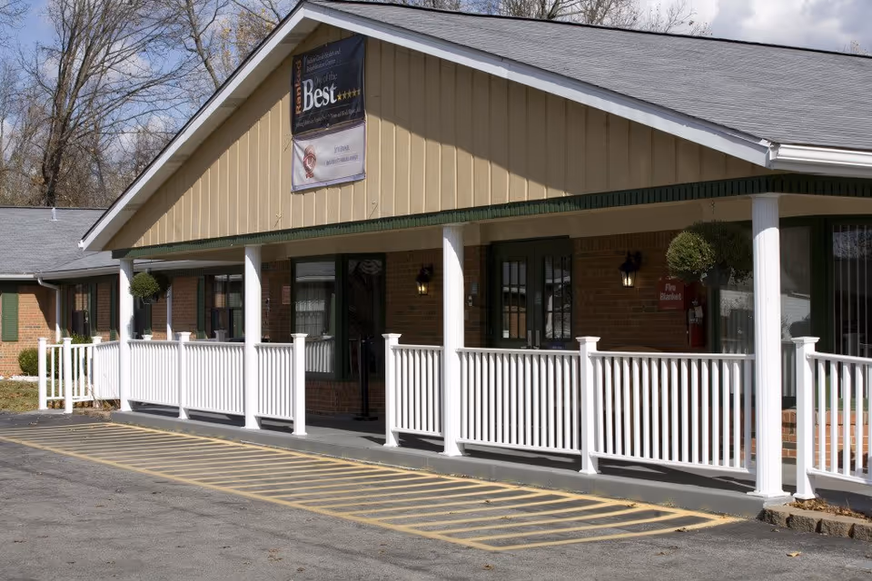 Senior care center exterior with brick walls, white porch railing, and entrance.