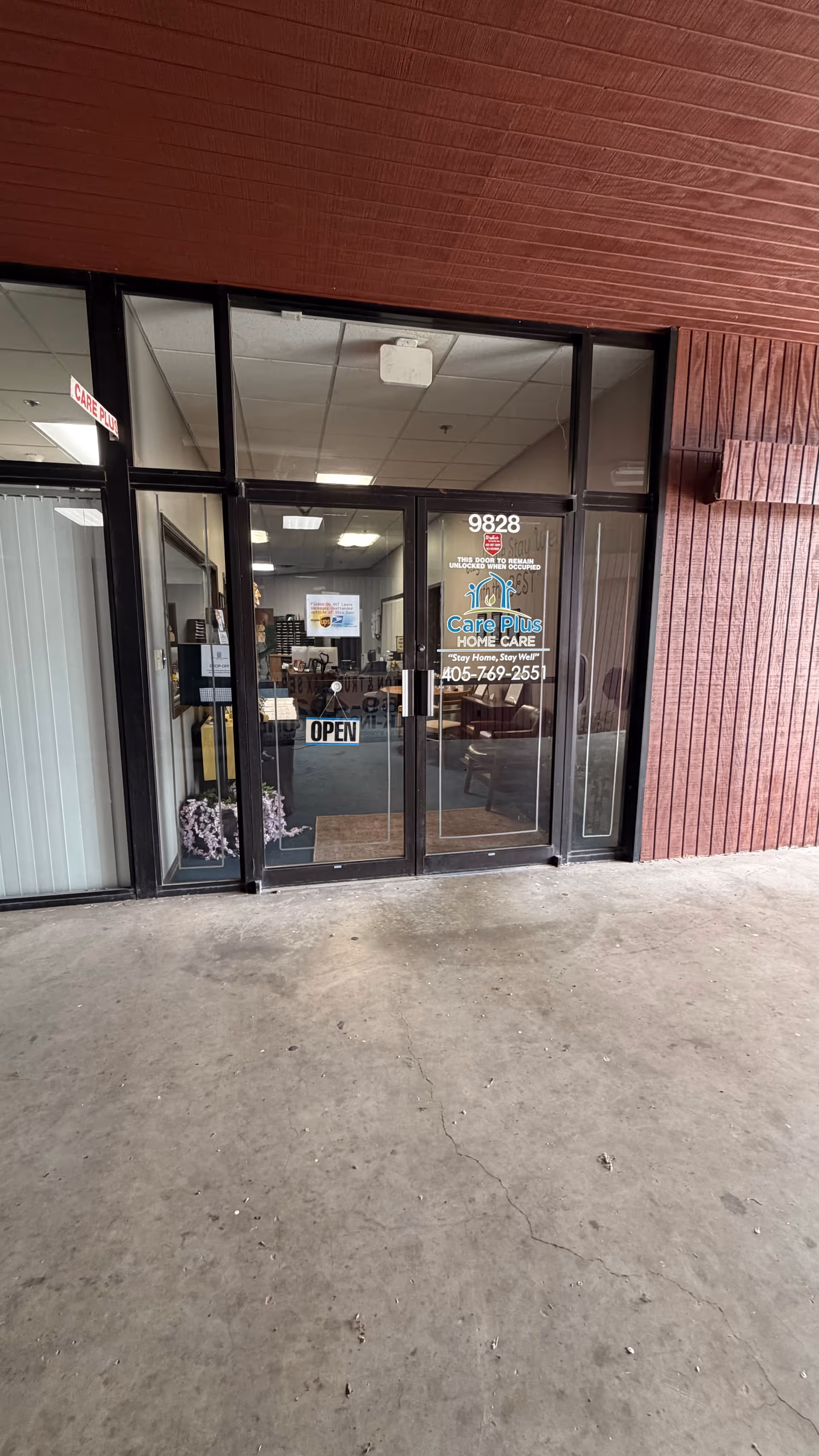 Glass storefront entrance for Care Plus Home Care with an open door.
