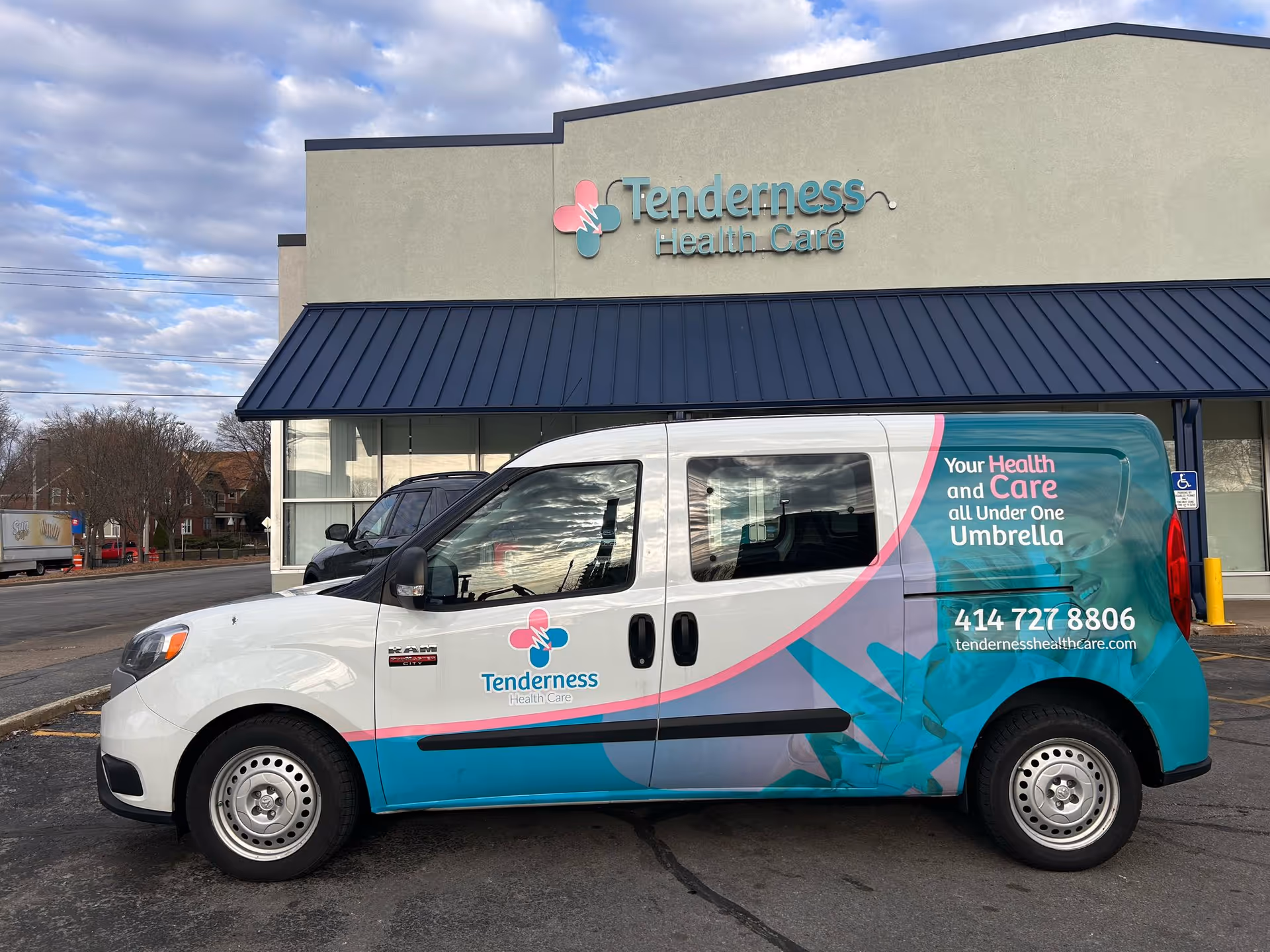 Front view of Tenderness Health Care building with a colorful service van parked outside.