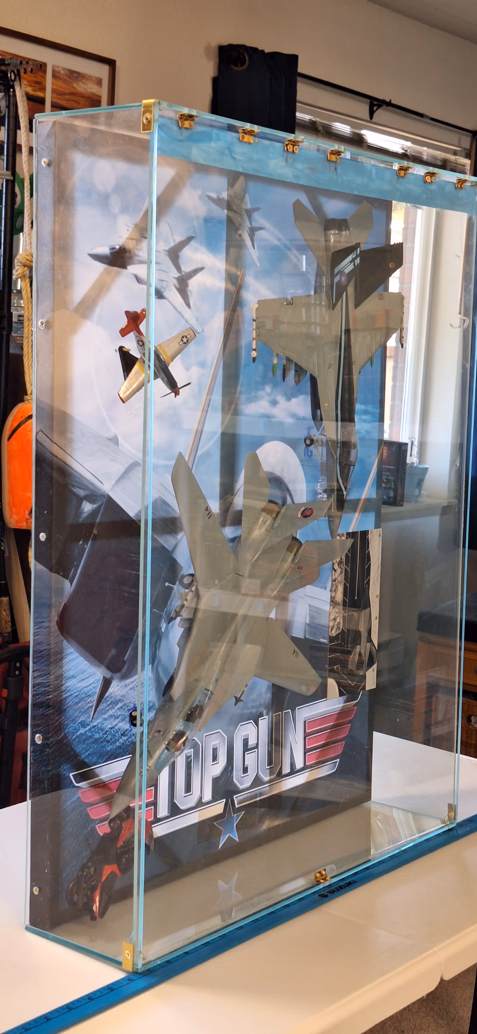 Glass display case with model airplanes inside a room at Tri Court Green River