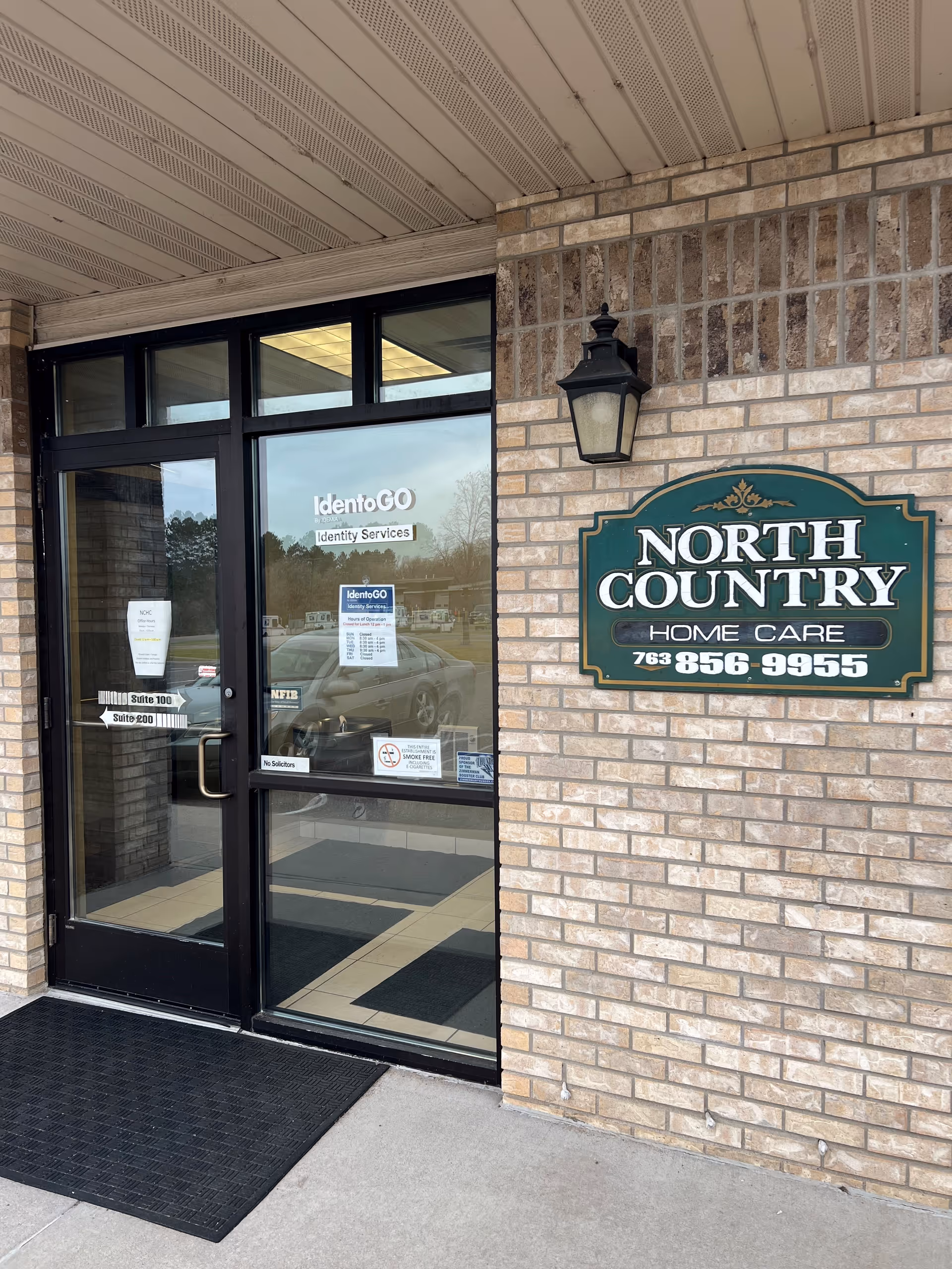 Brick building exterior with glass doors and North Country Home Care sign