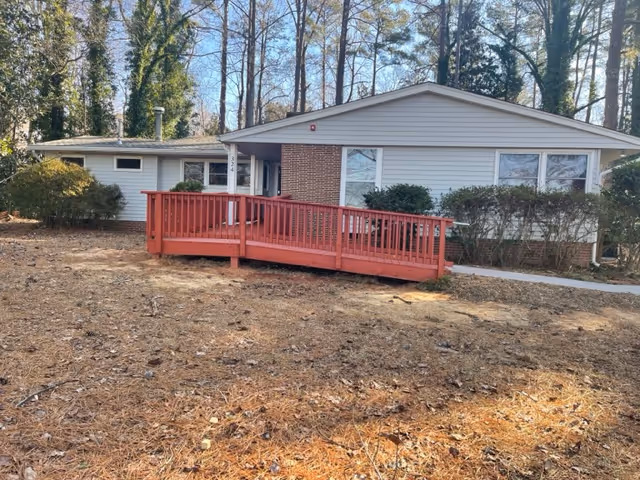 One-story senior care home with a red ramp leading to the entrance.
